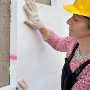 Woman insulating building