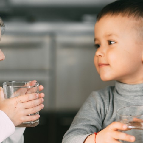 smiling children drinking water. 